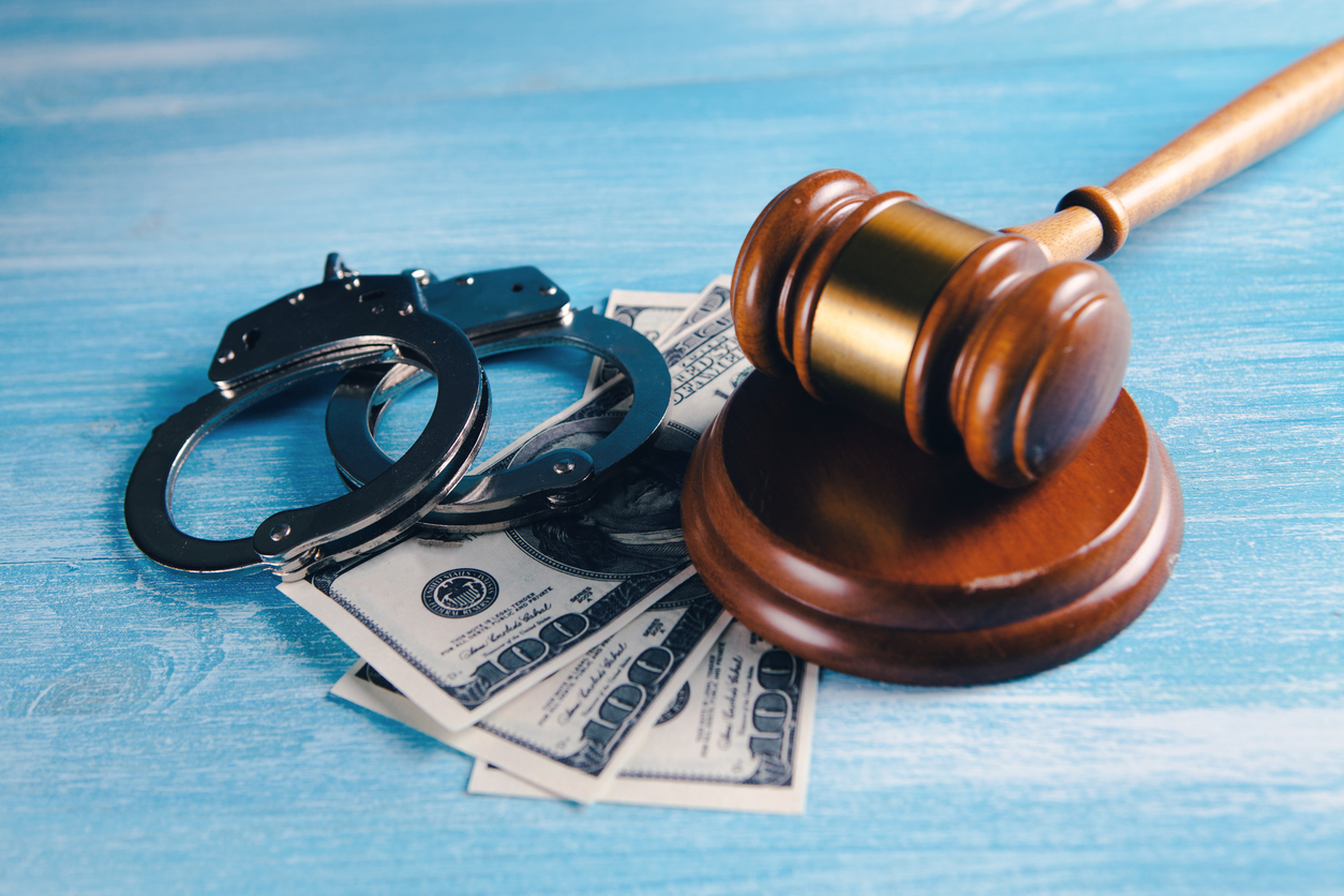 CMS fraud prevention priorities, handcuffs, money and judge's hammer