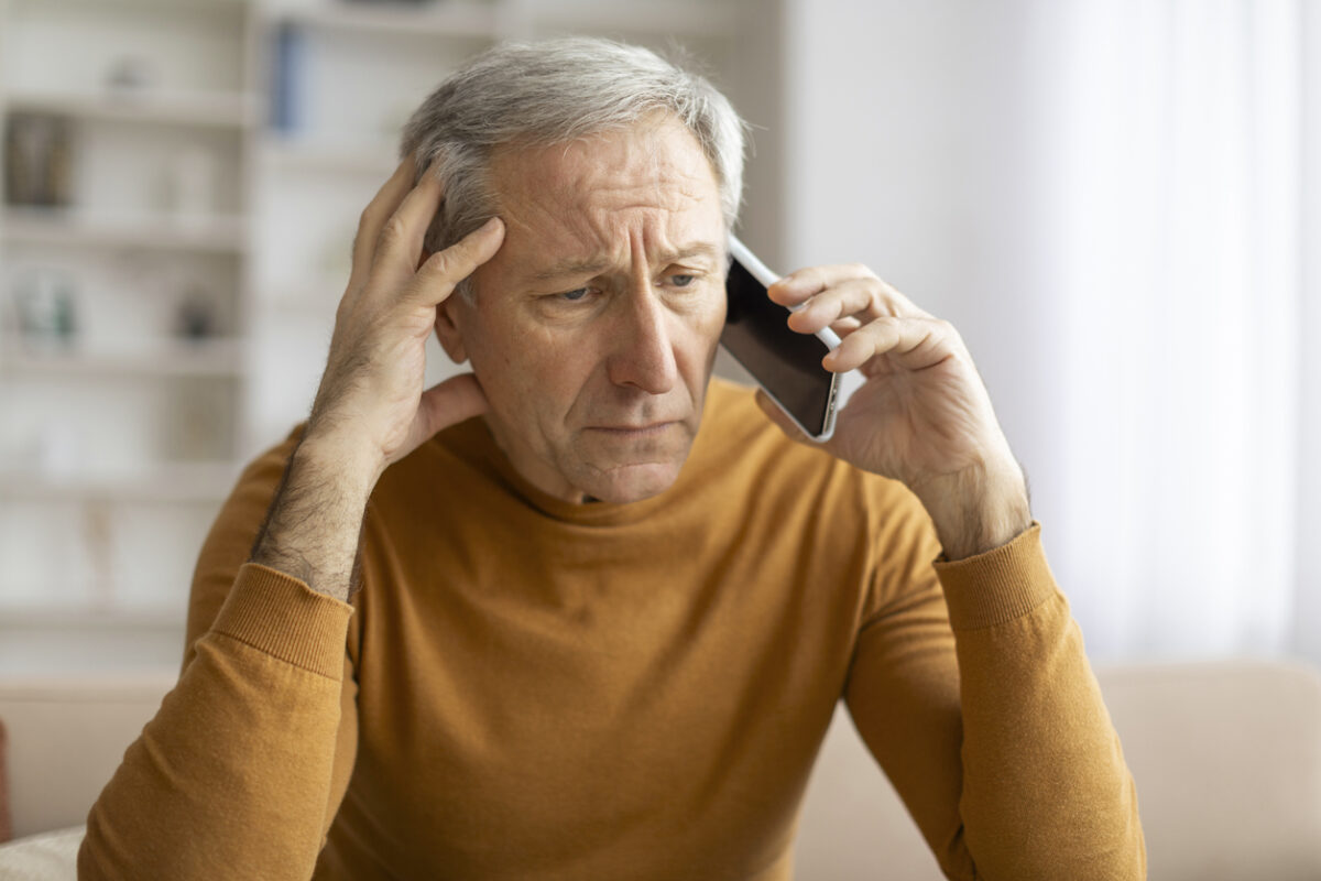 Medicare advantage, unwanted calls, unsolicited calls, senior man with concerned look on his face on the phone