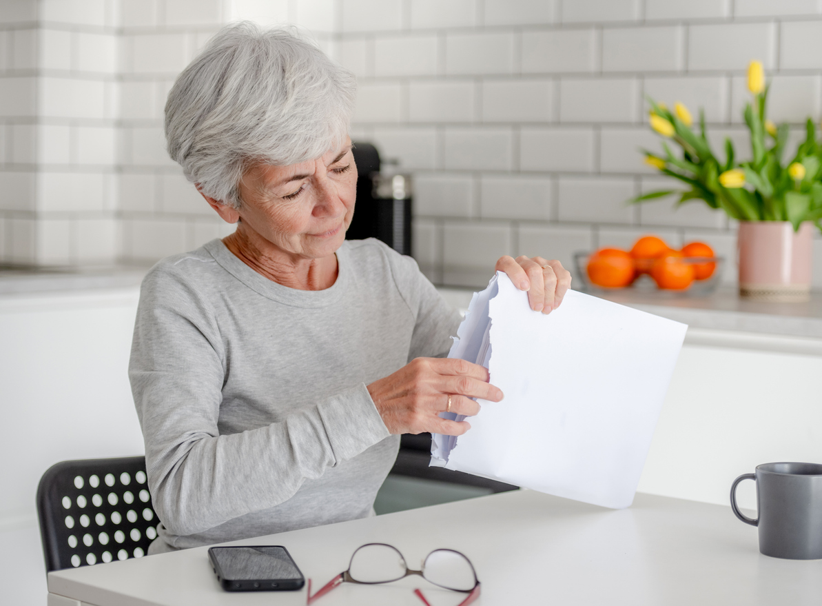 new Medicare card, Medicare card scam, older woman looking at mail
