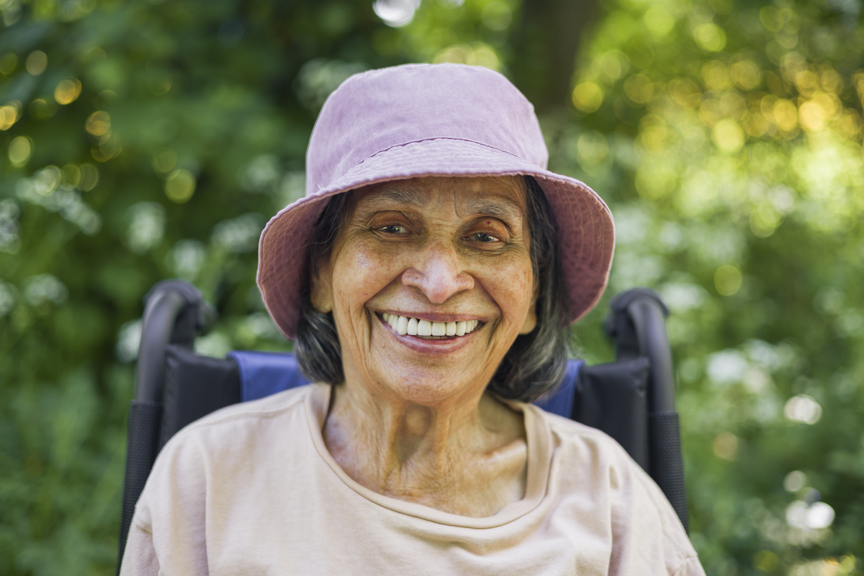 Protect Medicaid, HR 1, old Indian woman smiling in a wheelchair
